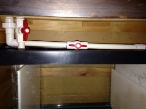 Return to display tank. Has a ball valve as well to regulate the flow for the pump.